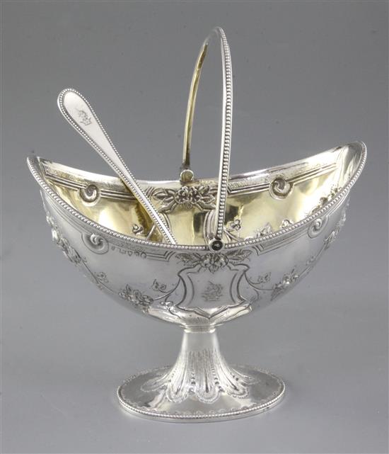 A Victorian silver swing handled sugar basket and sifter spoon, by Martin, Hall & Co, basket height 190mm, weight 7.7oz/241grms.